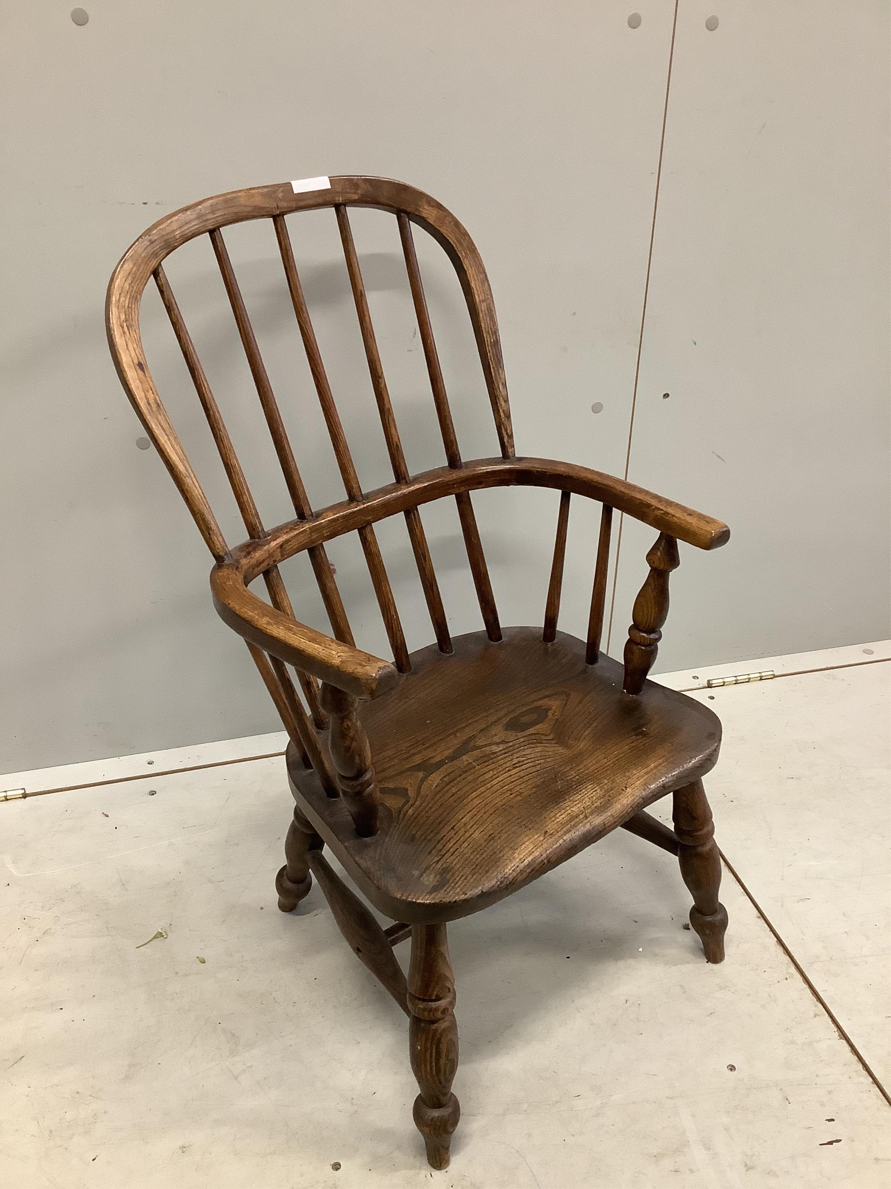 A 19th century ash and elm Windsor comb back child's chair, width 43cm, depth 32cm, height 77cm. Condition - fair